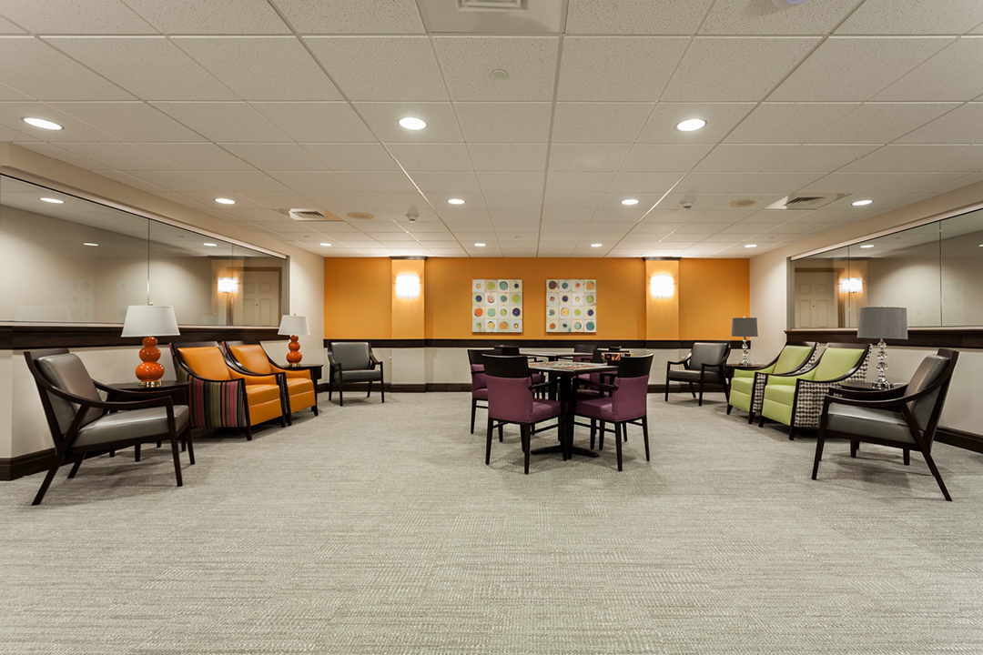 Interior image of a common space decorated in bright colors, with lots of seating available.