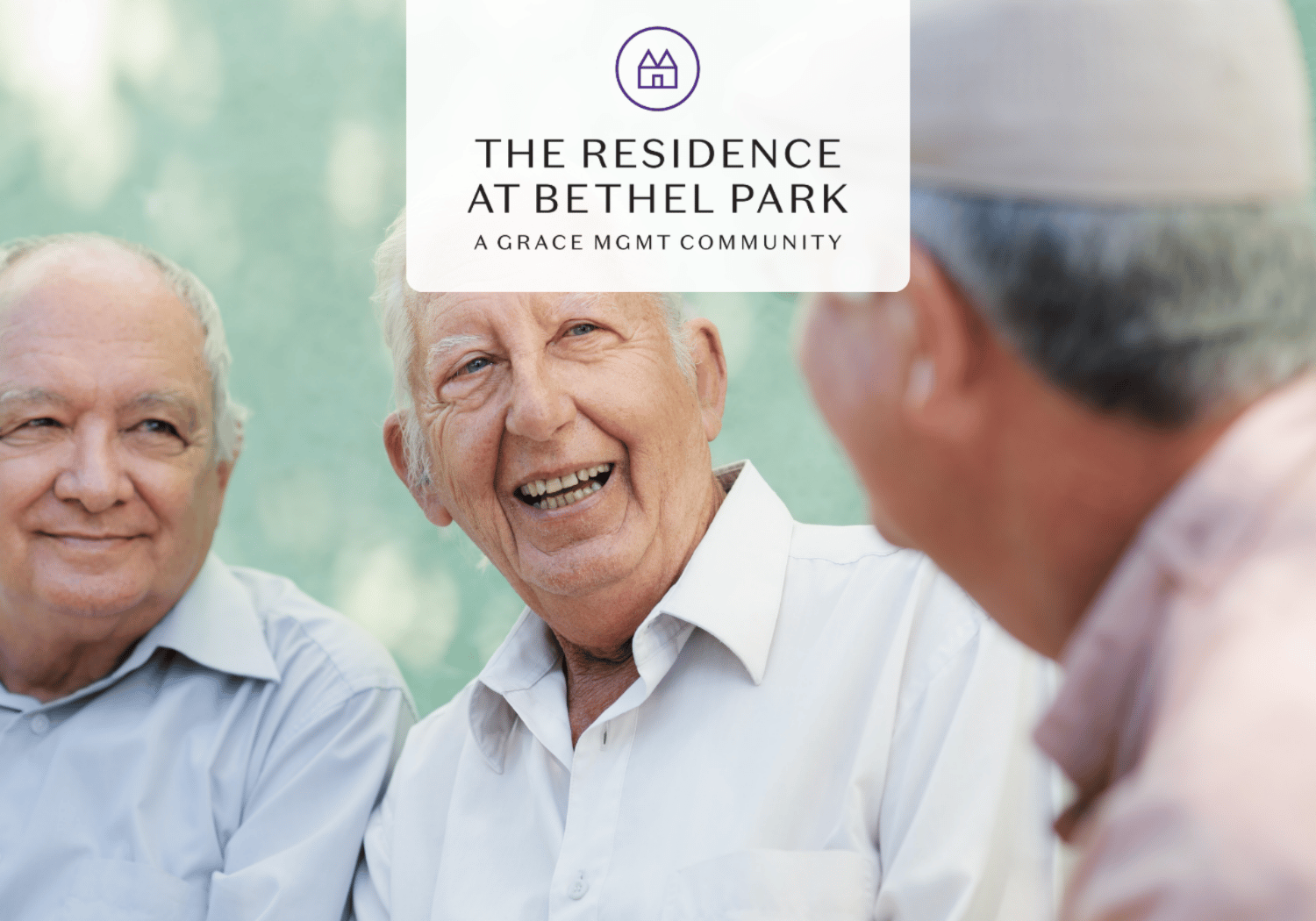 Three elderly men smiling together outdoors with The Residence at Bethel Park logo in the foreground.