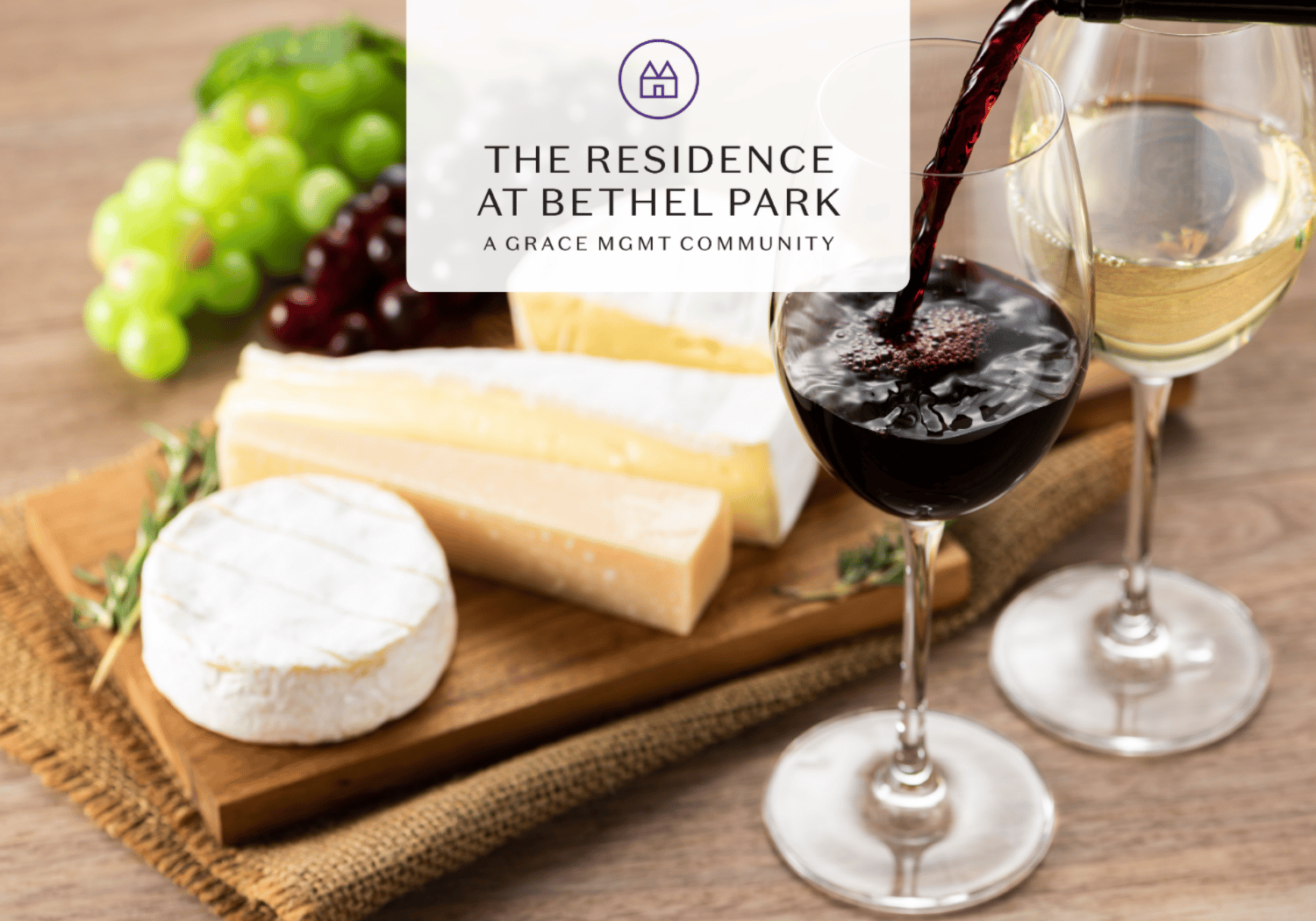 Wine glasses with red and white wine beside a cheese board and grapes, featuring The Residence at Bethel Park logo overlay.